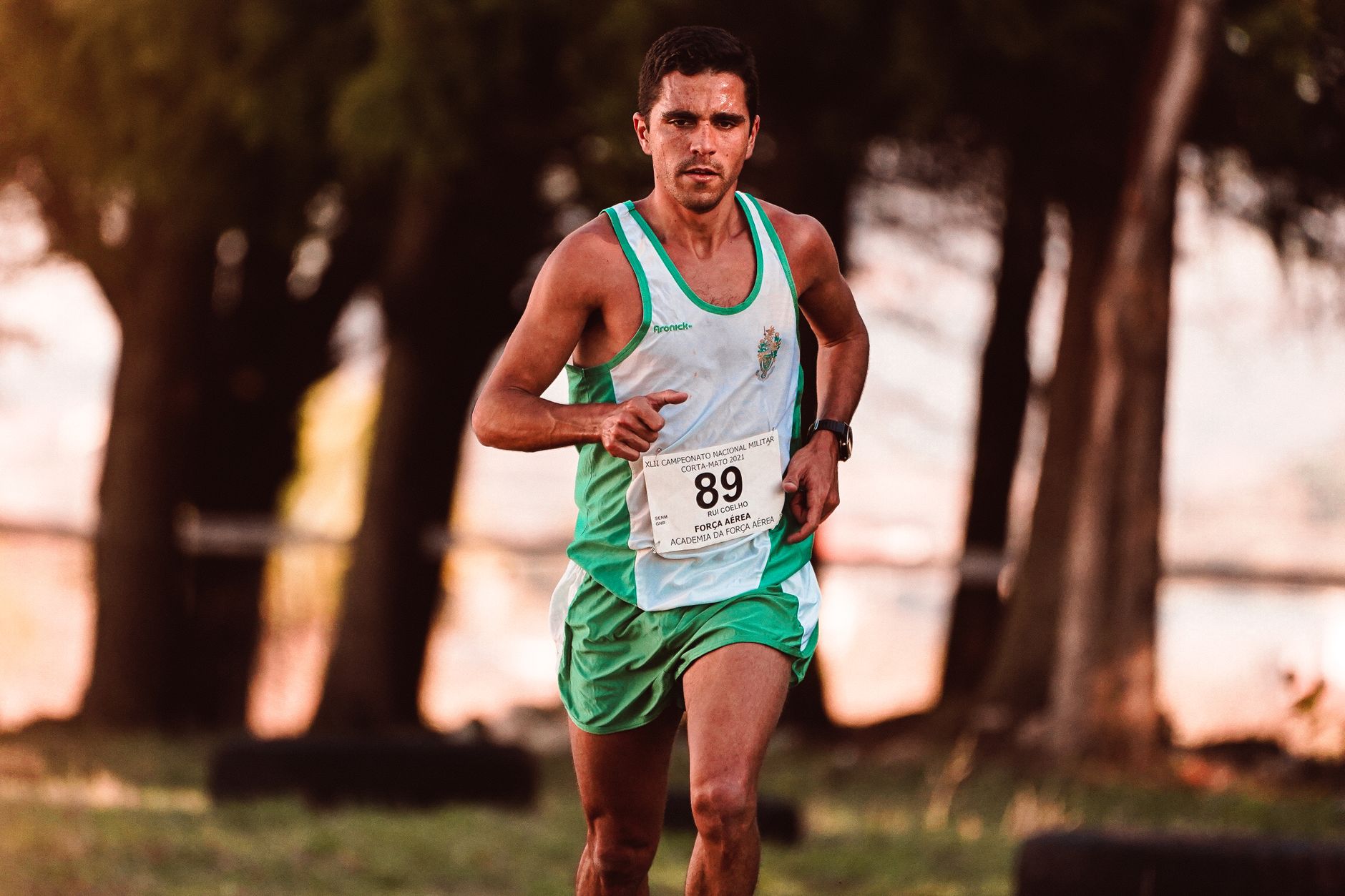 Männlicher Athlet, der entschlossen bei einem Outdoor-Marathon-Event läuft, in Bewegung festgehalten.
